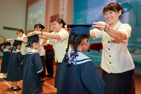 Graduating Preschoolers Touch their Parents with Gestures of Love and Gratitude